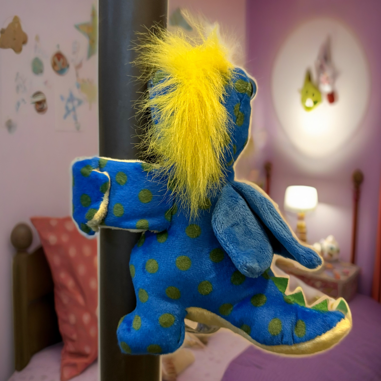 Blue plush toy with yellow hair on a pole in a child's bedroom